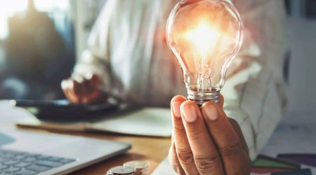 businessman hand holding light bulb. idea concept with innovation and inspiration